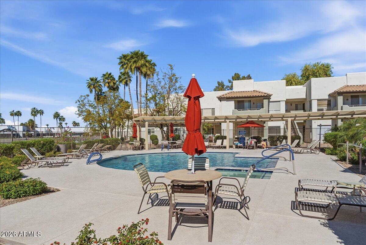 1825 West Ray Road, Unit 1106 Chandler, AZ 85224 - Photo 43 of 62 a view of a swimming pool with outdoor seating space
