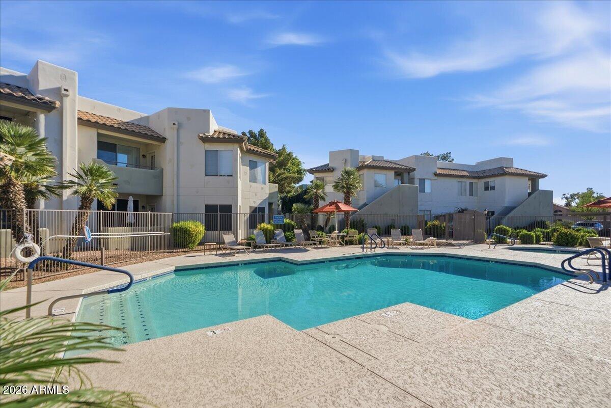 1825 West Ray Road, Unit 1106 Chandler, AZ 85224 - Photo 45 of 62 a view of a house with a swimming pool and a yard
