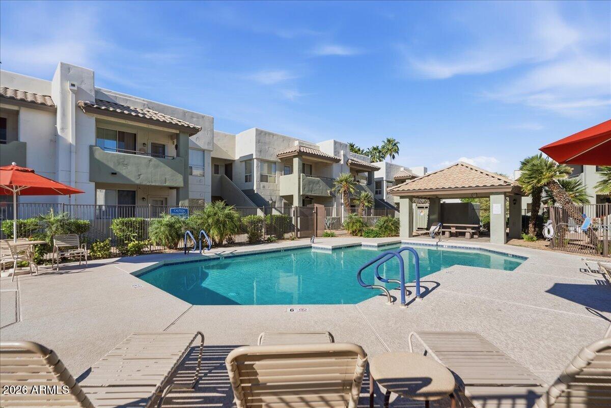1825 West Ray Road, Unit 1106 Chandler, AZ 85224 - Photo 48 of 62 a view of a swimming pool with a patio