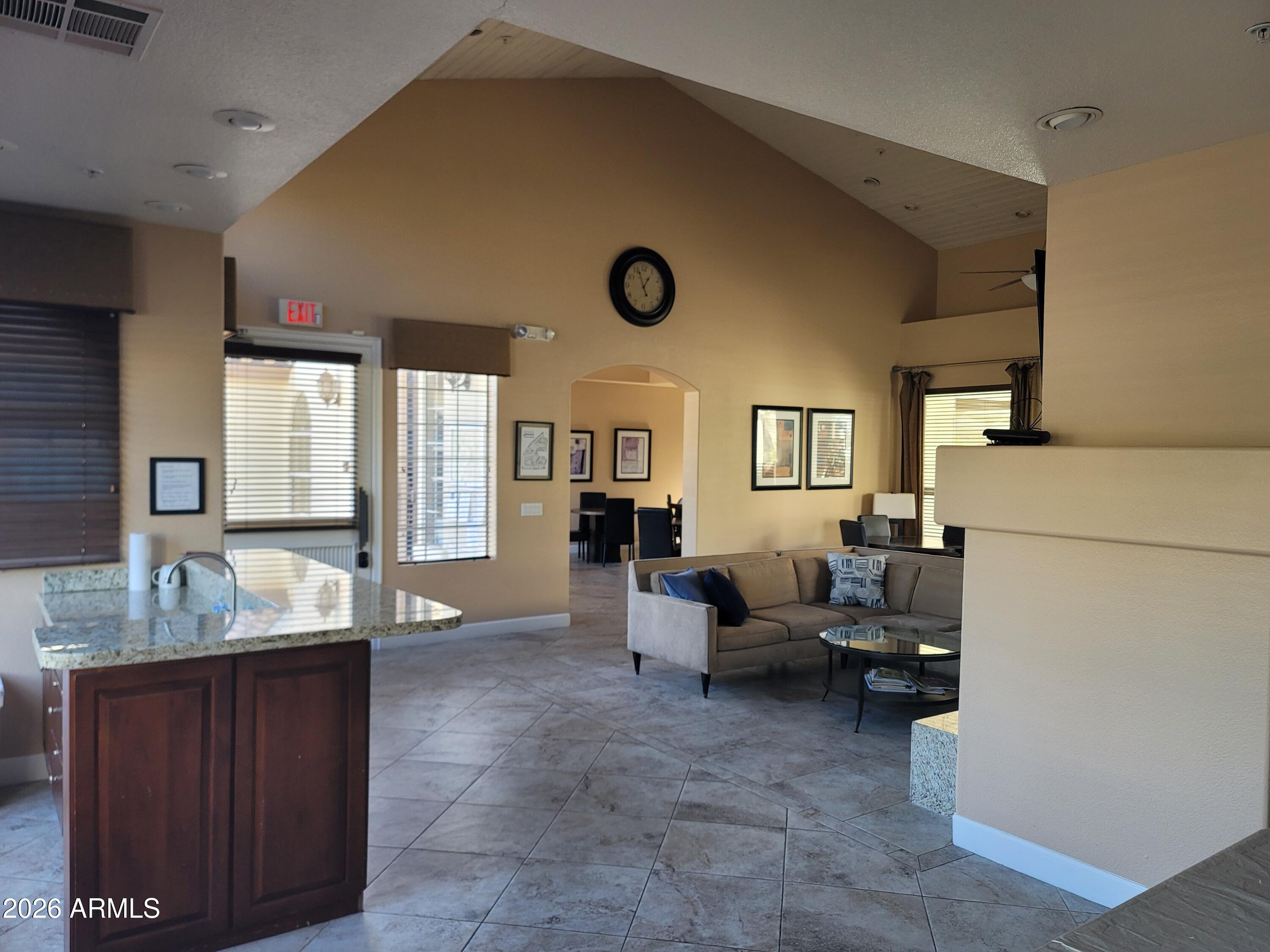 1825 West Ray Road, Unit 1106 Chandler, AZ 85224 - Photo 50 of 62 a living room with furniture and a large window