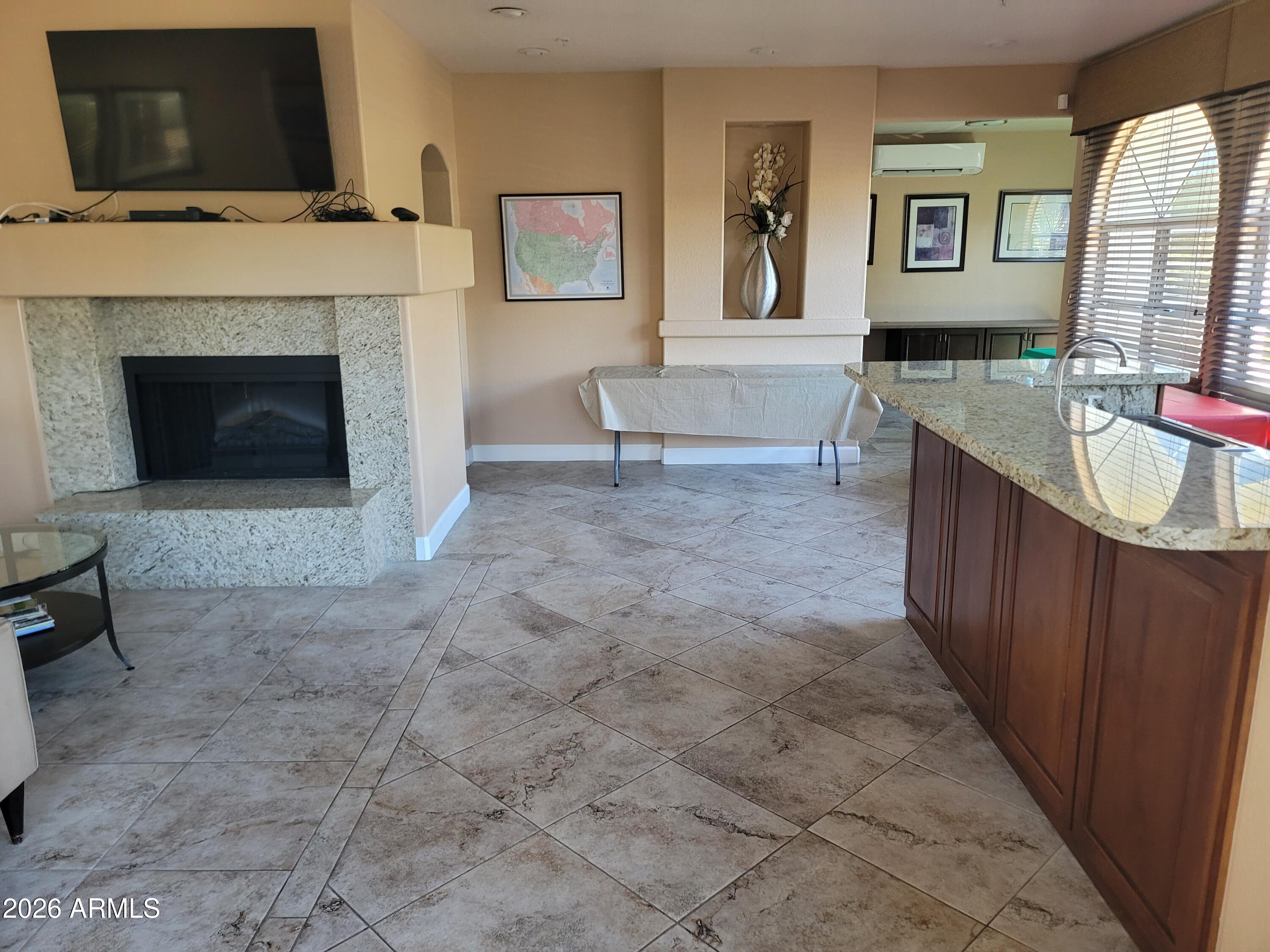 1825 West Ray Road, Unit 1106 Chandler, AZ 85224 - Photo 52 of 62 a living room with furniture and a fireplace