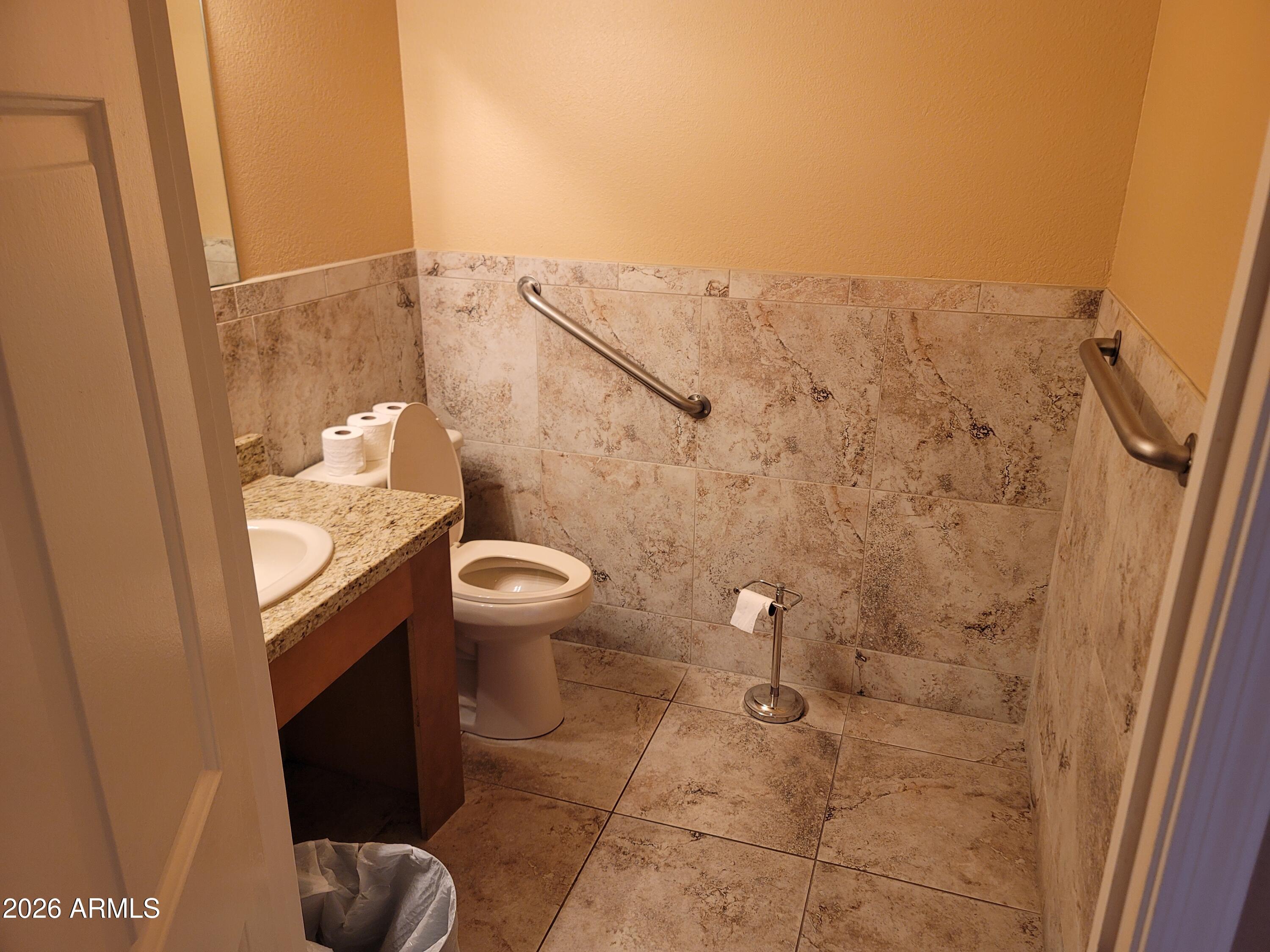 1825 West Ray Road, Unit 1106 Chandler, AZ 85224 - Photo 54 of 62 a bathroom with a granite countertop sink toilet and shower