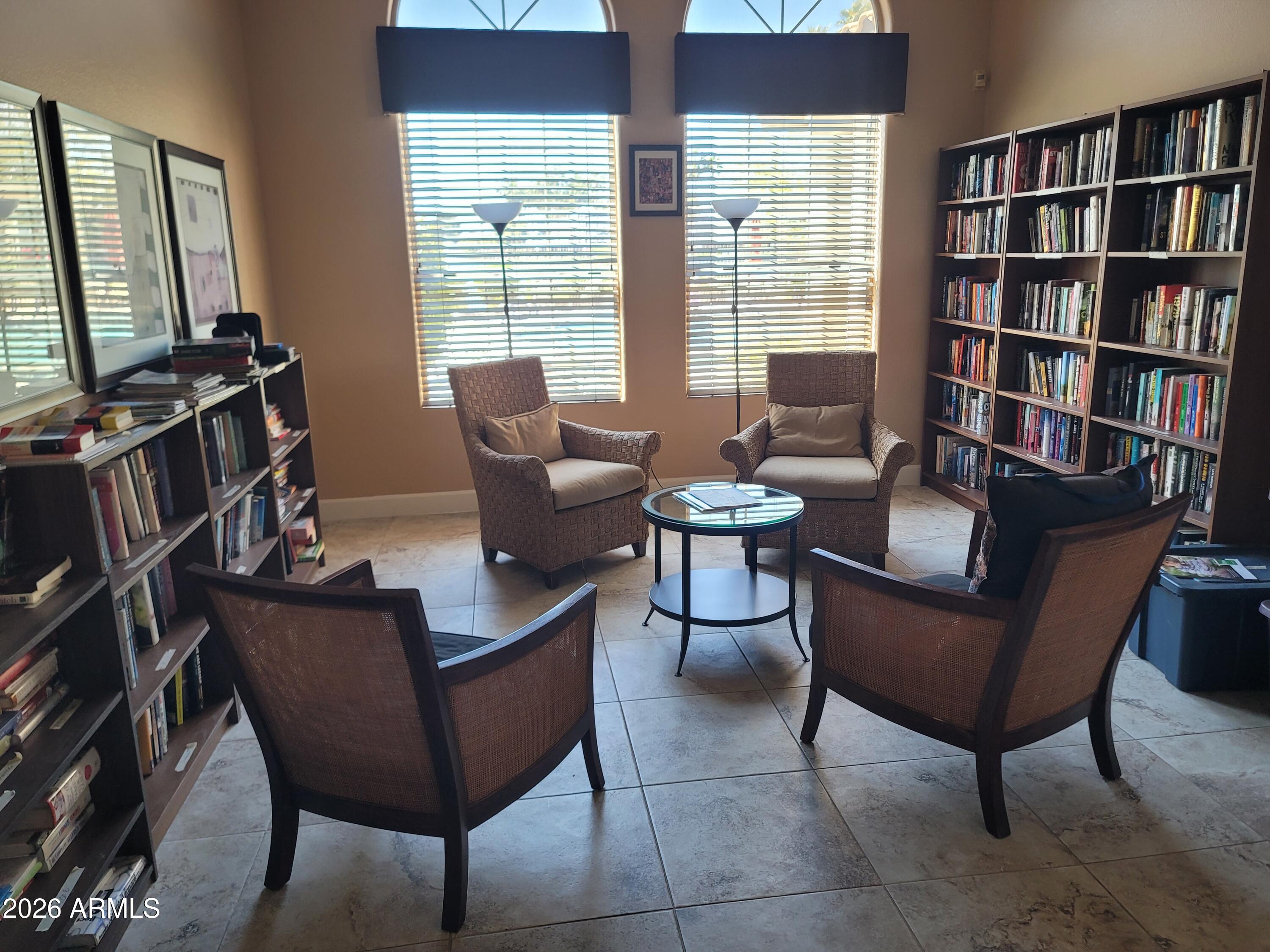1825 West Ray Road, Unit 1106 Chandler, AZ 85224 - Photo 57 of 62 a living room with furniture and a book shelf
