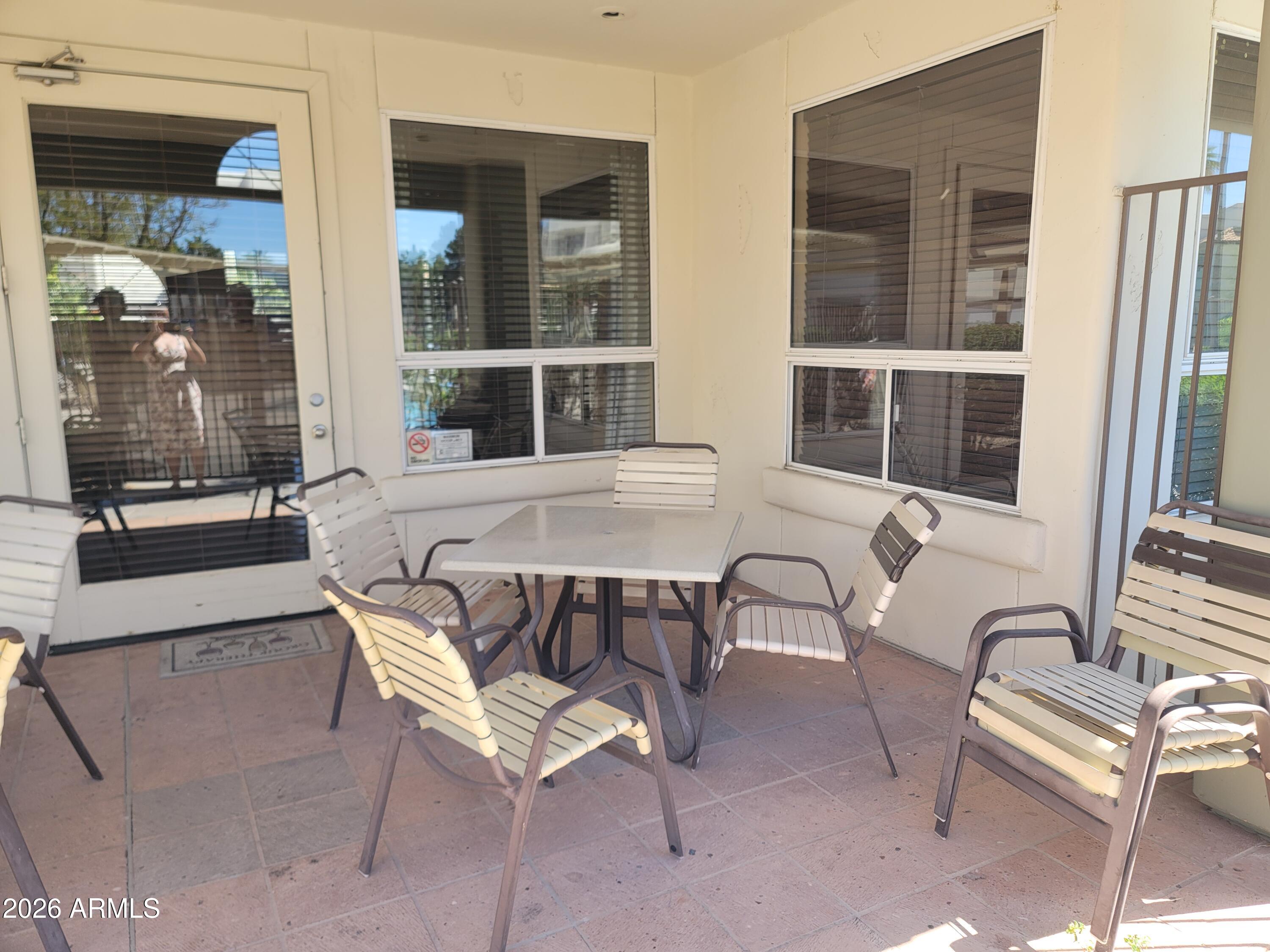 1825 West Ray Road, Unit 1106 Chandler, AZ 85224 - Photo 58 of 62 a view of a patio with table and chairs and potted plants