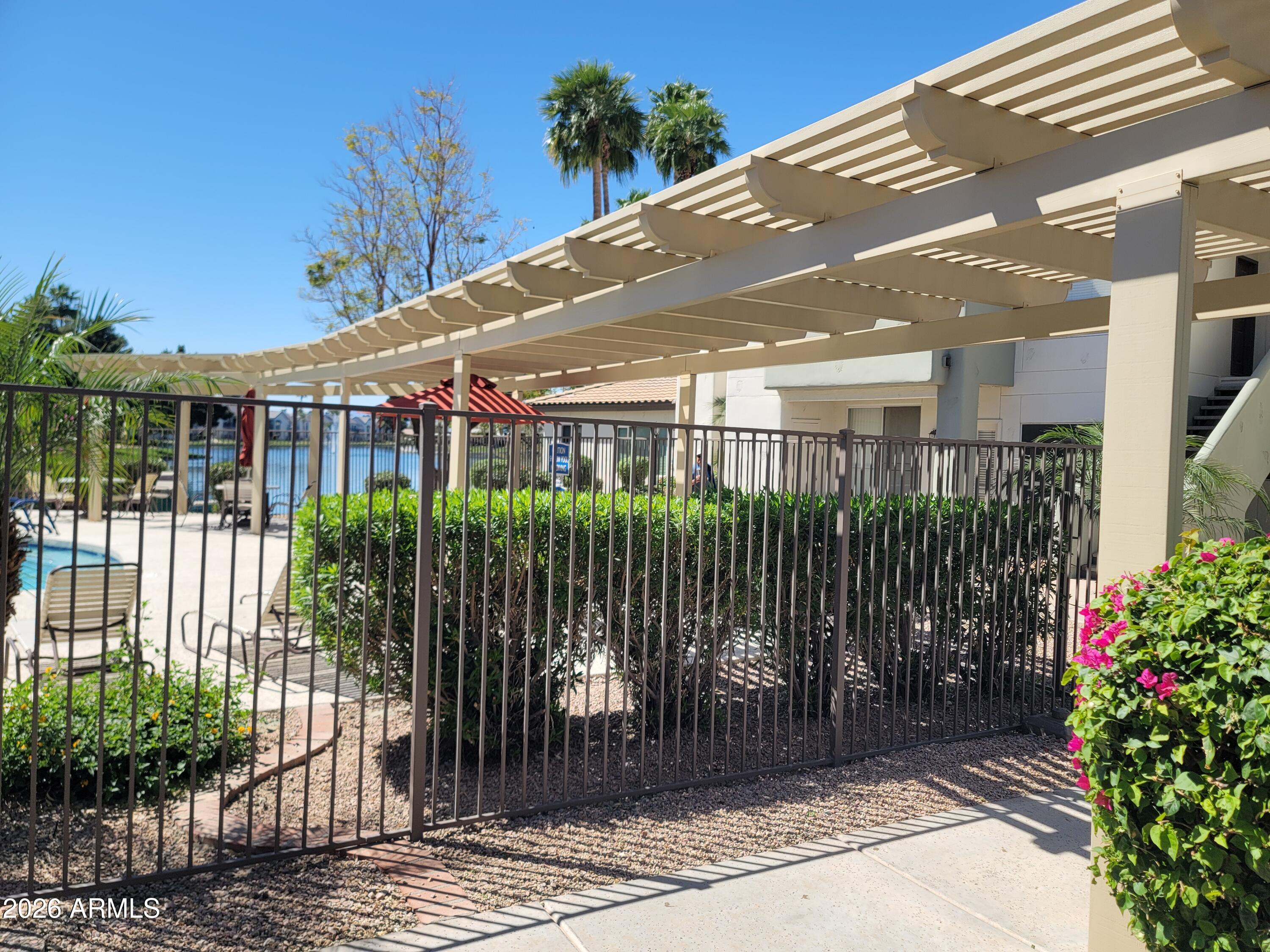 1825 West Ray Road, Unit 1106 Chandler, AZ 85224 - Photo 60 of 62 a front view of a house with a garden