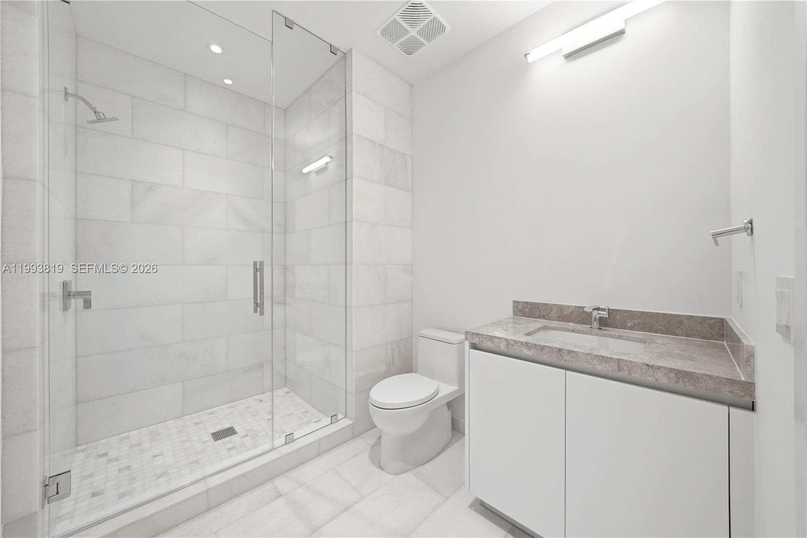 175 Southeast 25th Road, Unit 3102 Miami, FL 33129 - Photo 23 of 65 a bathroom with a granite countertop sink a toilet and shower
