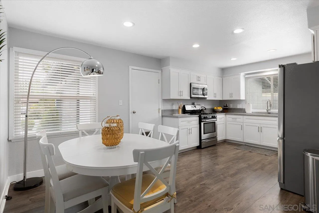 14050 Halper Road Poway, CA 92064 - Photo 8 of 29 a kitchen with stainless steel appliances granite countertop a stove a refrigerator a sink a dining table and chairs