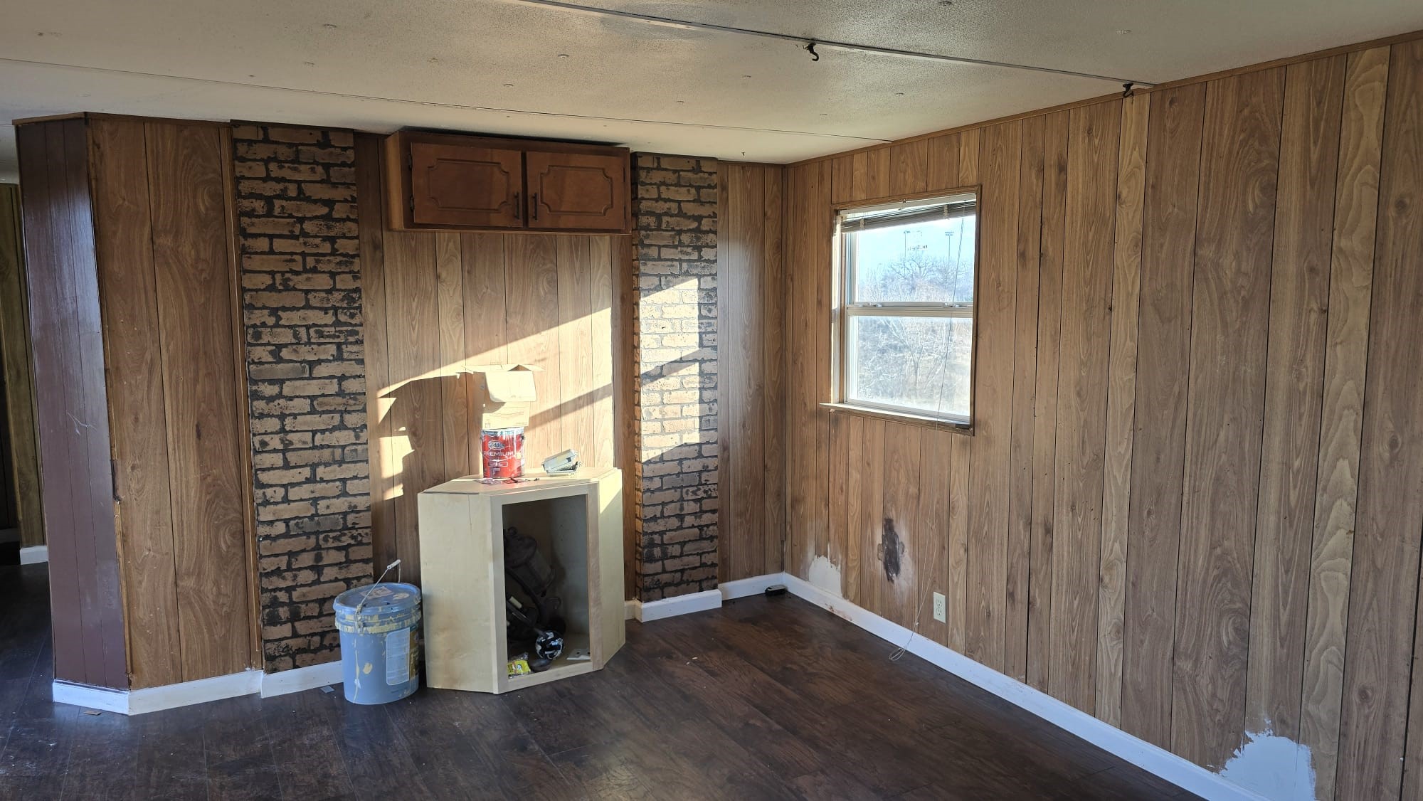 18509 Blake Manor Road Manor, TX 78653 - Photo 4 of 17 a view of an empty room with wooden floor and a window