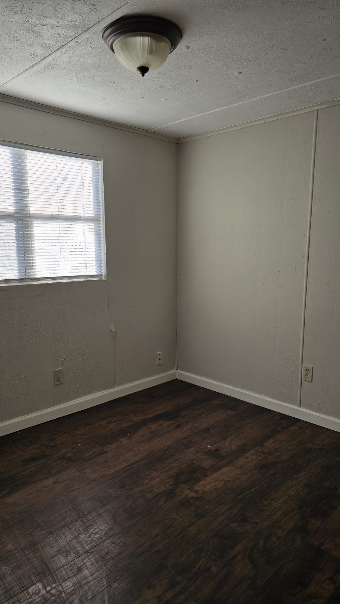 18509 Blake Manor Road Manor, TX 78653 - Photo 6 of 17 an empty room with wooden floor and windows