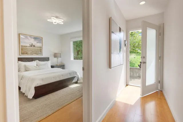 a bedroom with a bed and a painting on the wall