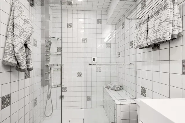 a bathroom with a bathtub and shower