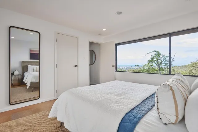 a bedroom with a large bed and a large window