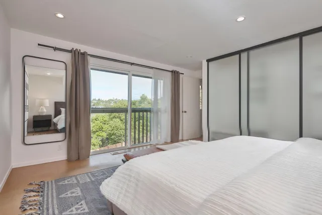 a large bedroom with a large bed and a large window