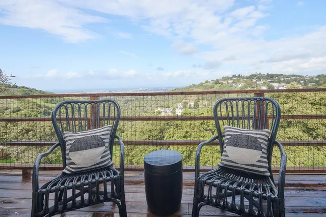 a view of a chairs and table on the balcony