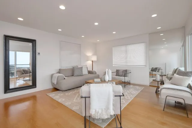 a living room with furniture and large window