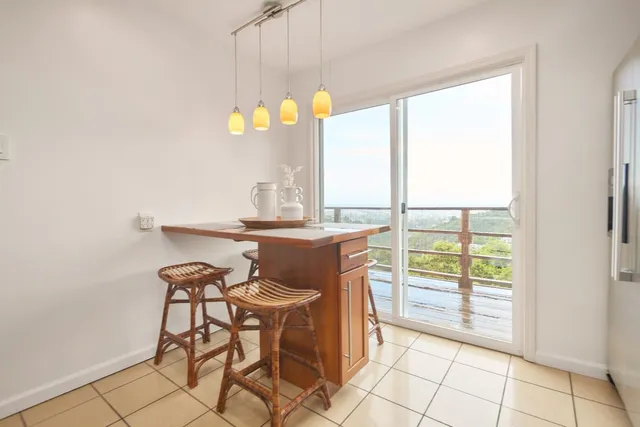 a view of a dining table chairs and chandelier