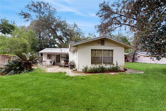 a view of a house with a yard and sitting area