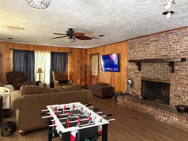 a living room with furniture a fireplace and a wooden floor