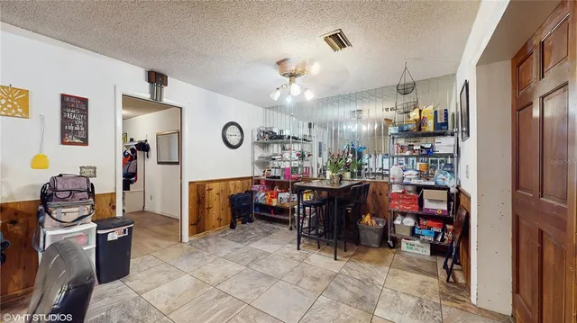 a view of a dining room with furniture and a chandelier