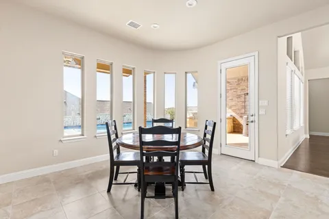 a dining room with furniture and window