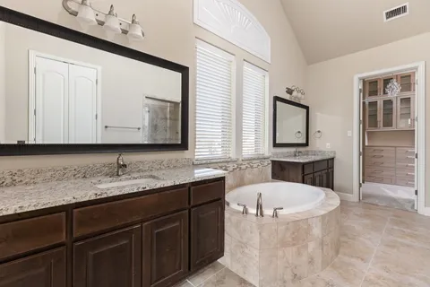 a bathroom with a tub sink and mirror
