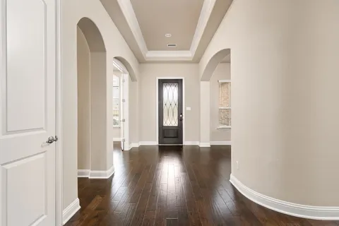 a view of an entryway with wooden floor