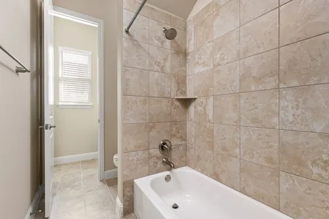 a bathroom with a white bath tub and a shower