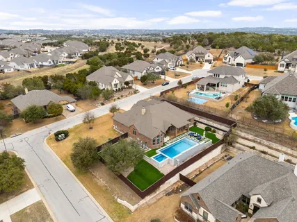 an aerial view of residential houses with outdoor space