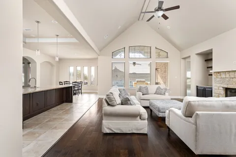 a large living room with furniture fireplace and a large window