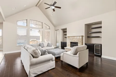 a living room with furniture fireplace and a flat screen tv