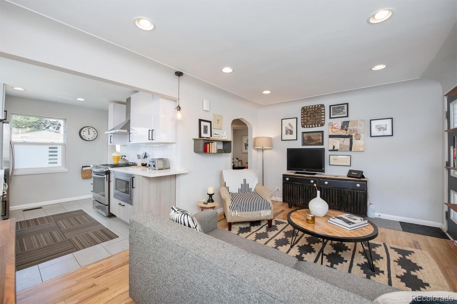 2745 King Street Denver, CO 80211 - Photo 6 of 24 a living room with furniture and a dining table with kitchen view