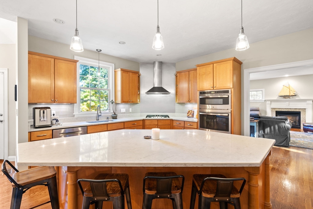 279 Gleasondale Road Stow, MA 01775 - Photo 8 of 39 a kitchen with a table chairs sink and refrigerator