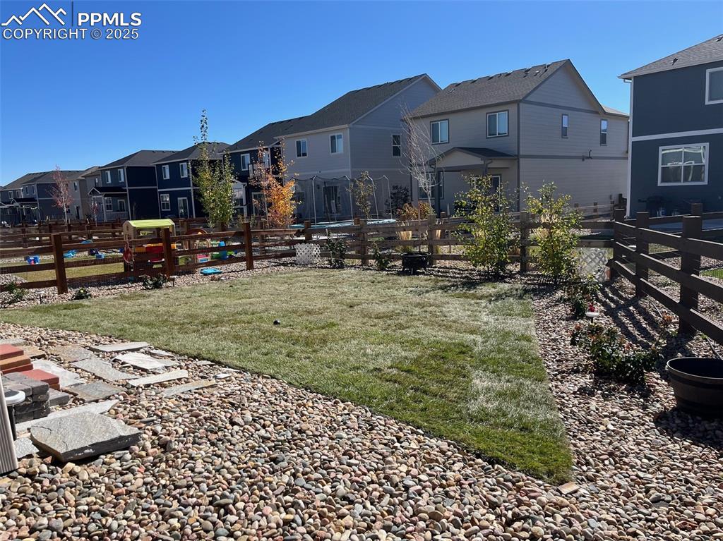 2325 Coyote Mint Drive Monument, CO 80132 - Photo 26 of 26 a view of a house with backyard sitting area and garden