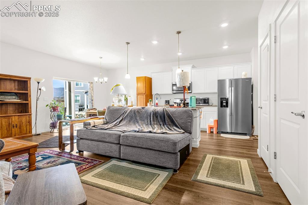 2325 Coyote Mint Drive Monument, CO 80132 - Photo 4 of 26 a living room with furniture and a table