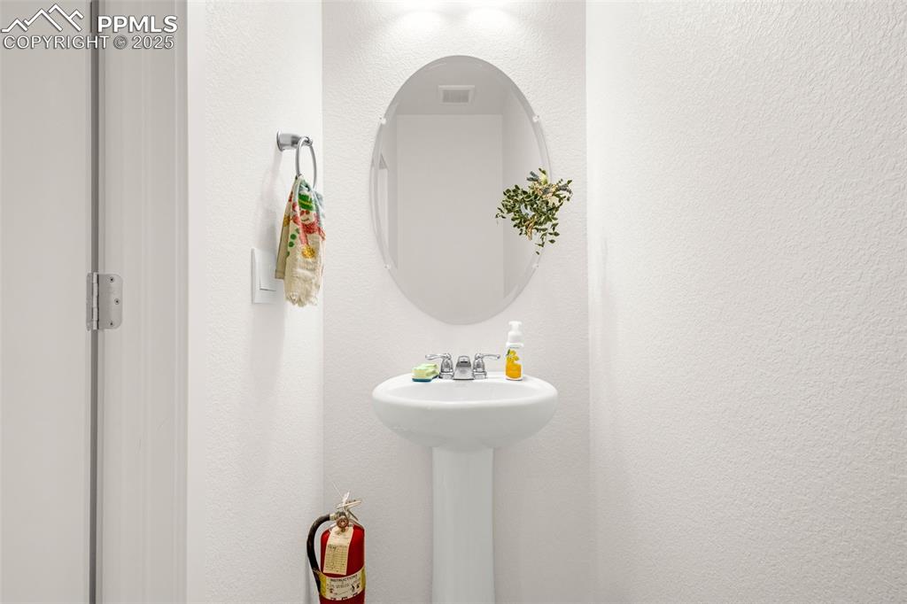 2325 Coyote Mint Drive Monument, CO 80132 - Photo 9 of 26 a bathroom with a sink and a mirror