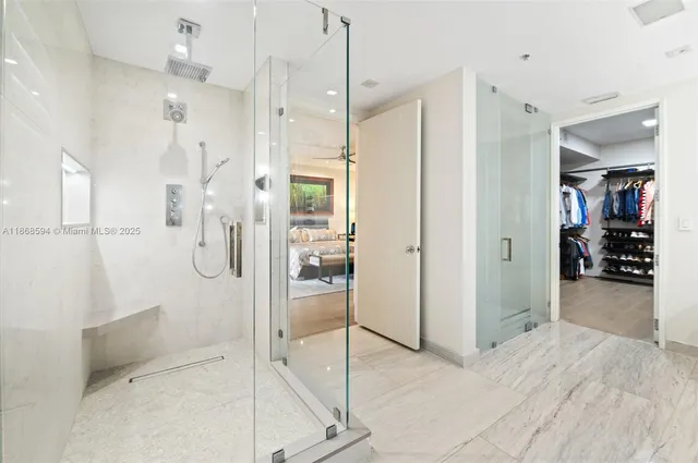 a view of walk in closet with clothes and shoes