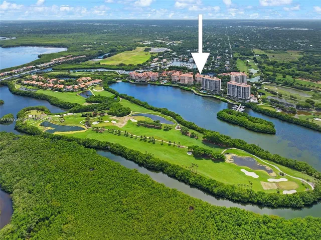 a living room with furniture and large windows
