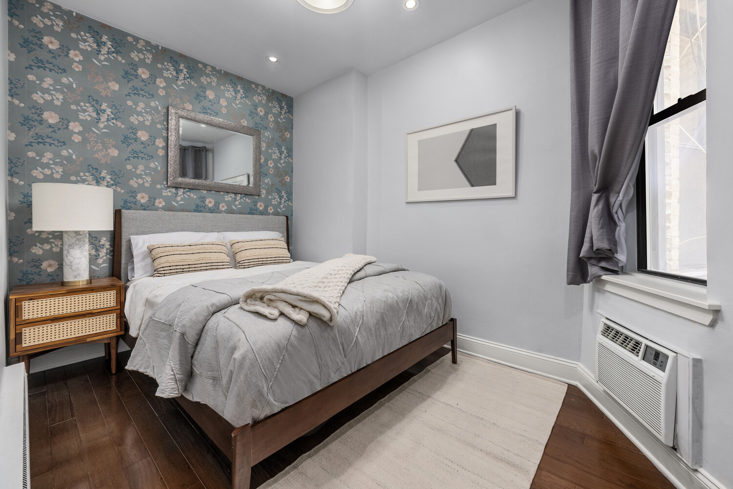 433 West 24th Street, Unit 3D Manhattan, NY 10011 - Photo 4 of 7 a bedroom with a large bed and a fireplace