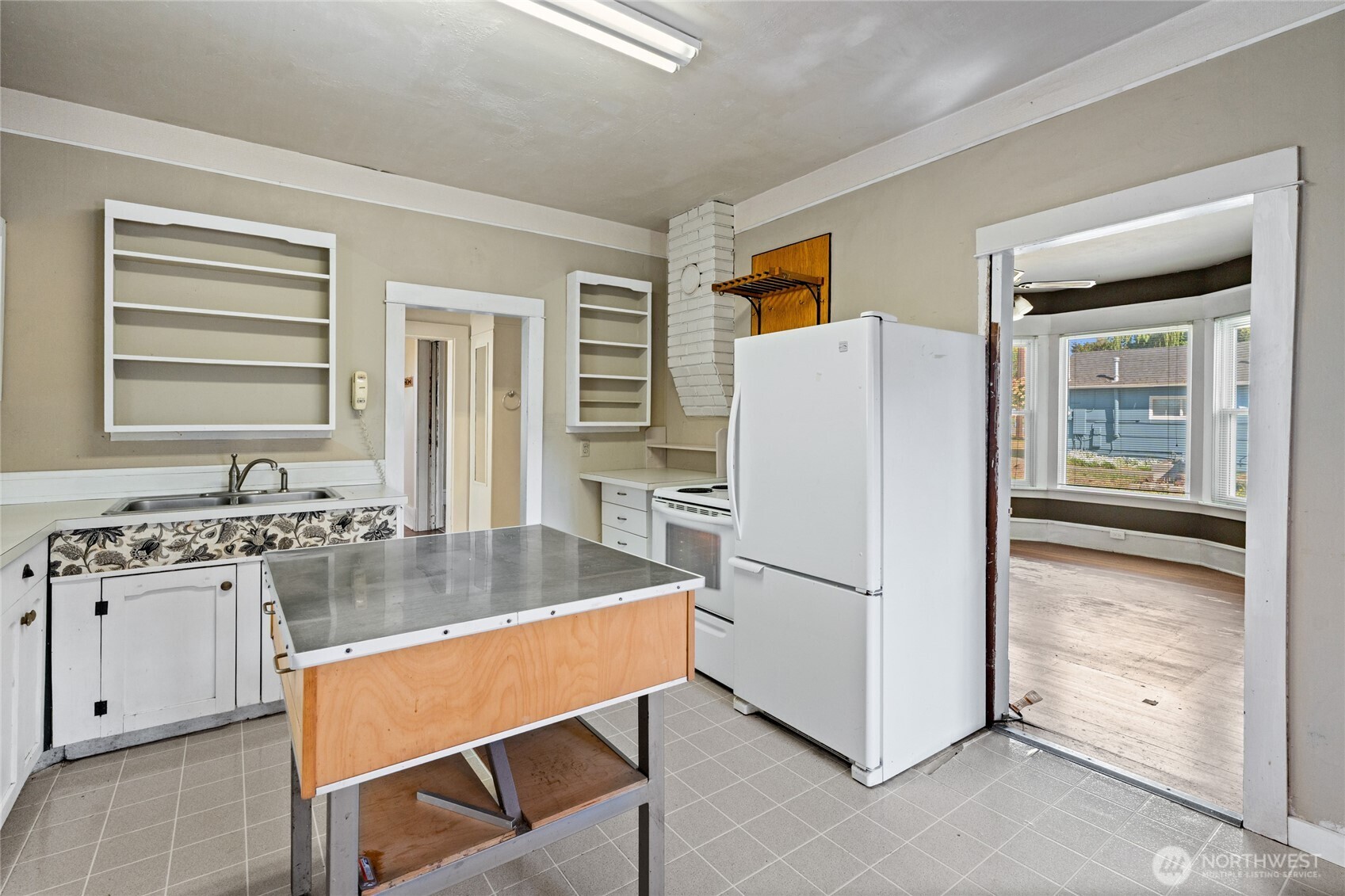1118 Thompson Street Sumner, WA 98390 - Photo 17 of 39 a kitchen with refrigerator cabinets and wooden floor