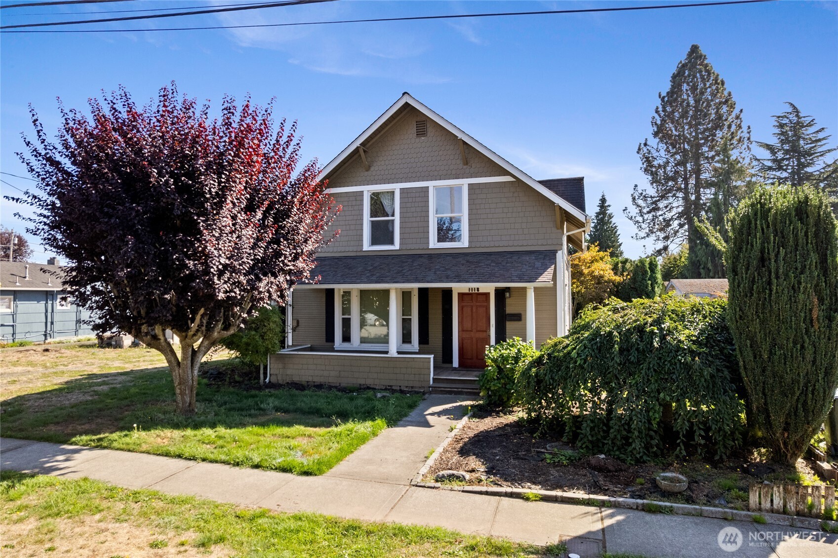 1118 Thompson Street Sumner, WA 98390 - Photo 2 of 39 a front view of a house with a yard