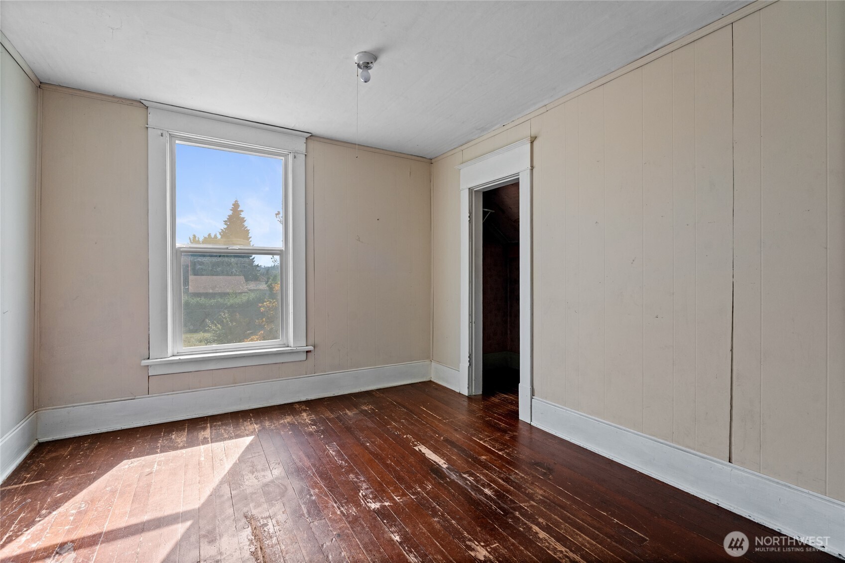 1118 Thompson Street Sumner, WA 98390 - Photo 21 of 39 a view of an empty room with wooden floor and a window