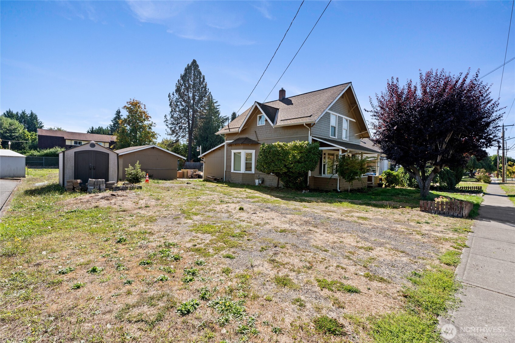 1118 Thompson Street Sumner, WA 98390 - Photo 32 of 39 a view of a house with a yard and potted plants