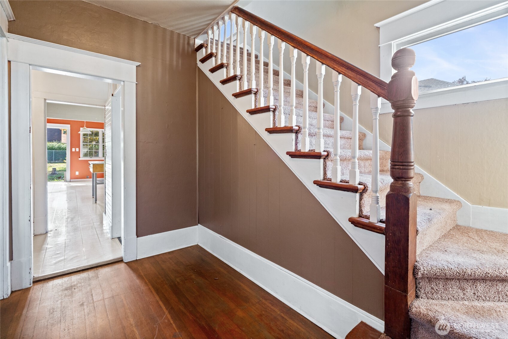 1118 Thompson Street Sumner, WA 98390 - Photo 4 of 39 a view of staircase with wooden floor and white walls