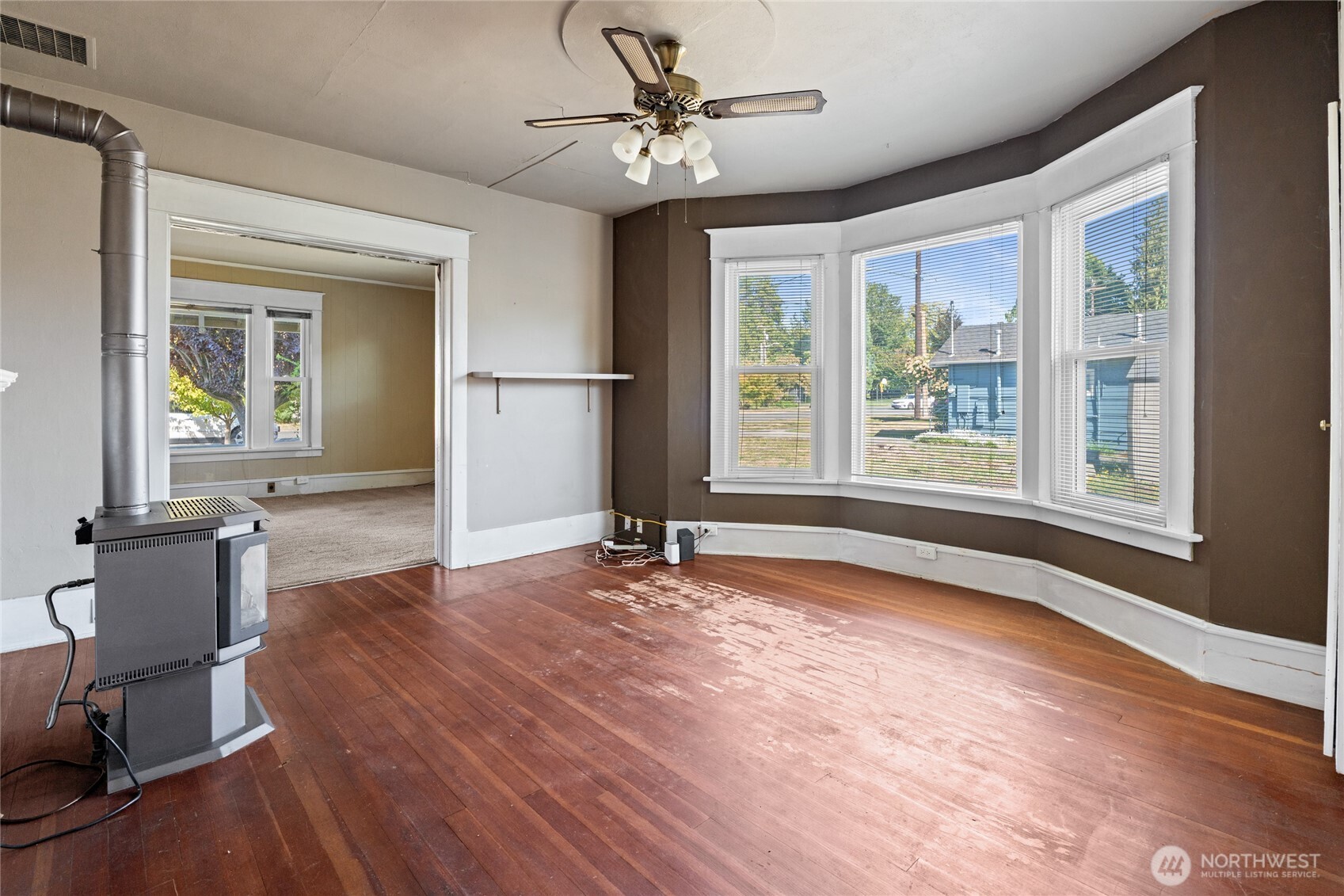 1118 Thompson Street Sumner, WA 98390 - Photo 10 of 39 a view of an empty room with a window and wooden floor