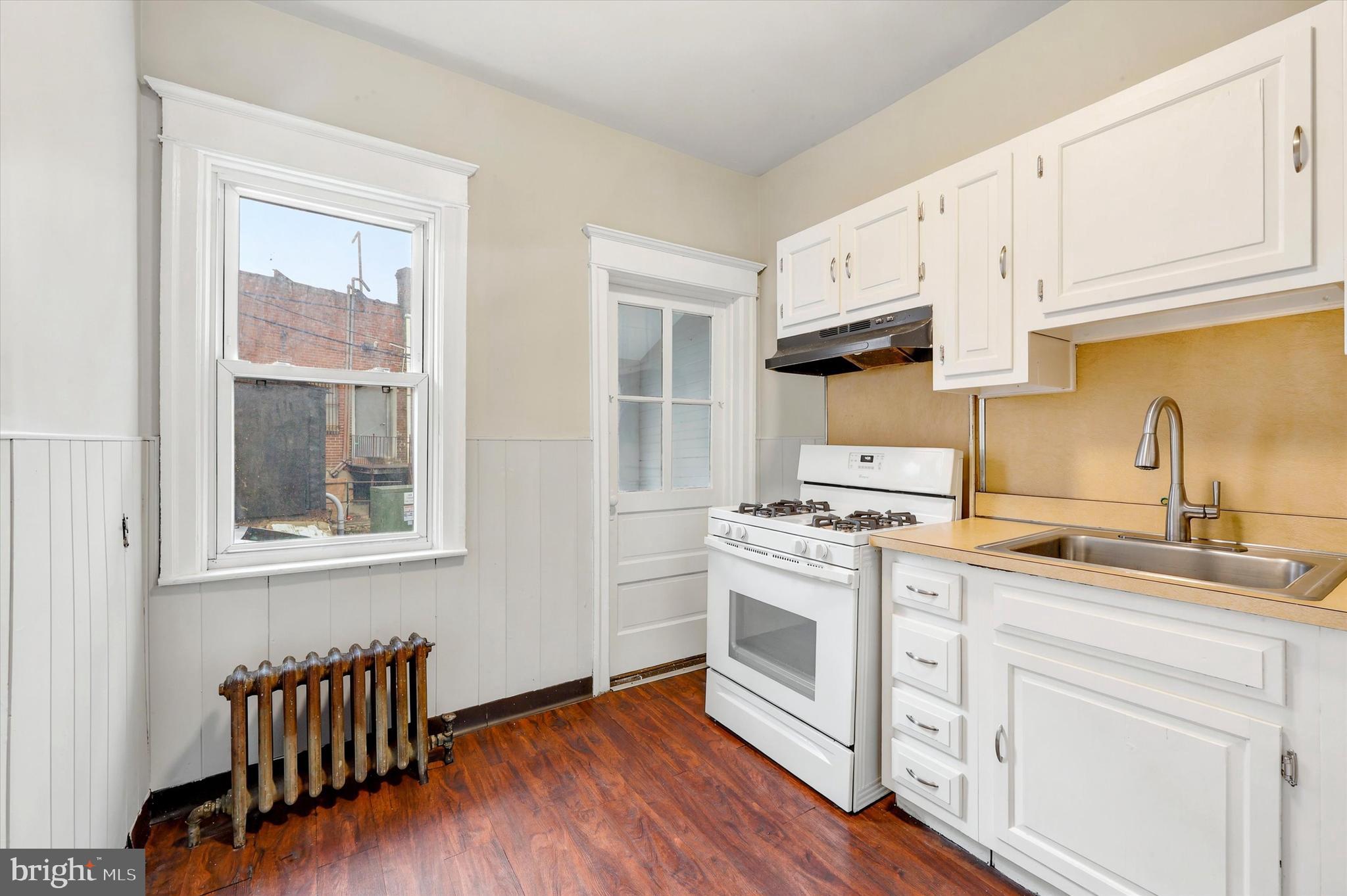 55 Richfield Road Upper Darby, PA 19082 - Photo 9 of 33 a kitchen with cabinets wooden floor and stainless steel appliances
