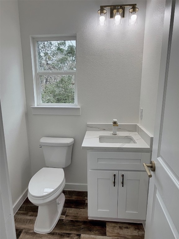 410 Coast Loop Trinity, TX 75862 - Photo 14 of 30 a bathroom with a toilet a sink and a window