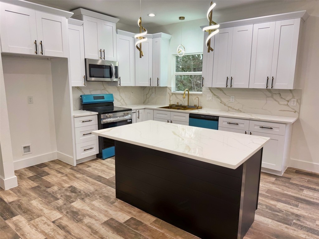 410 Coast Loop Trinity, TX 75862 - Photo 2 of 30 a kitchen with a sink a stove and cabinets