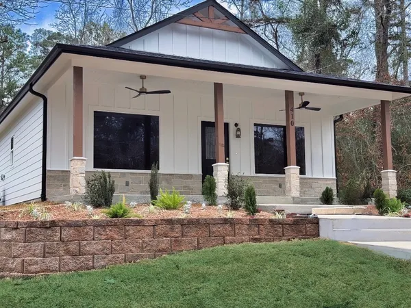 a sign board on the side of the house