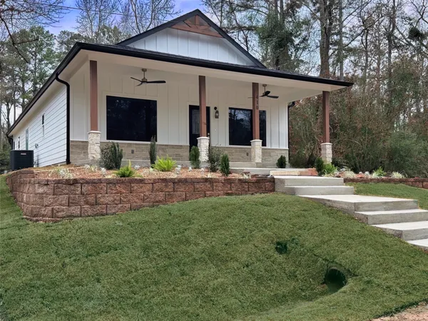 a view of the house with backyard and sitting area