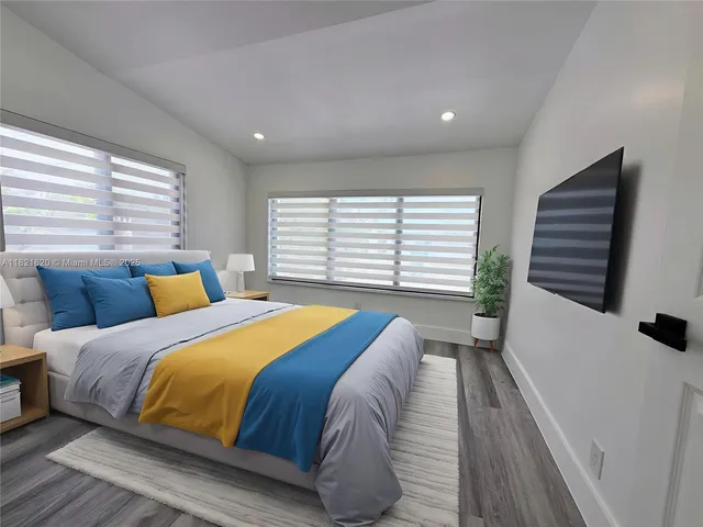 a bedroom with a large bed and a large window